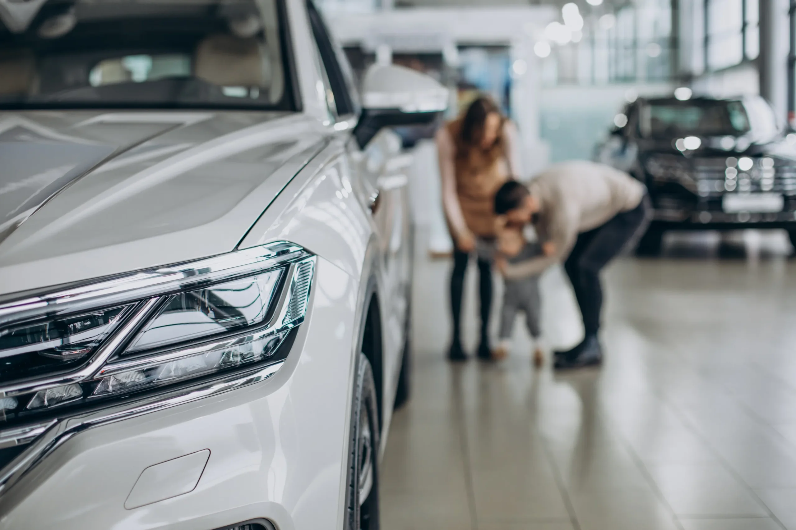 family-with-baby-girl-choosing-car-car-salon