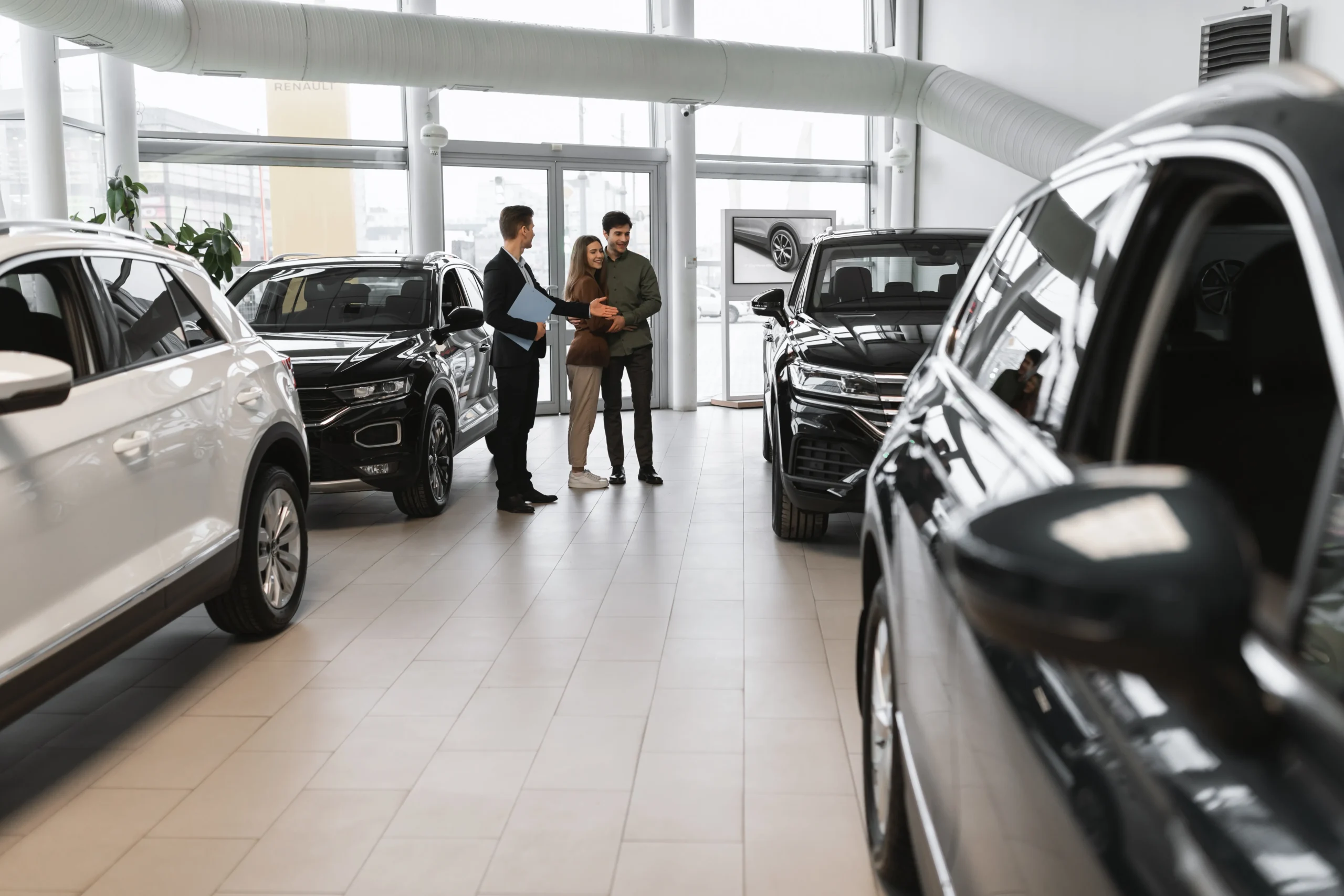 full-length-millennial-couple-choosing-new-car-having-discussion-with-auto-salesman-vehicle